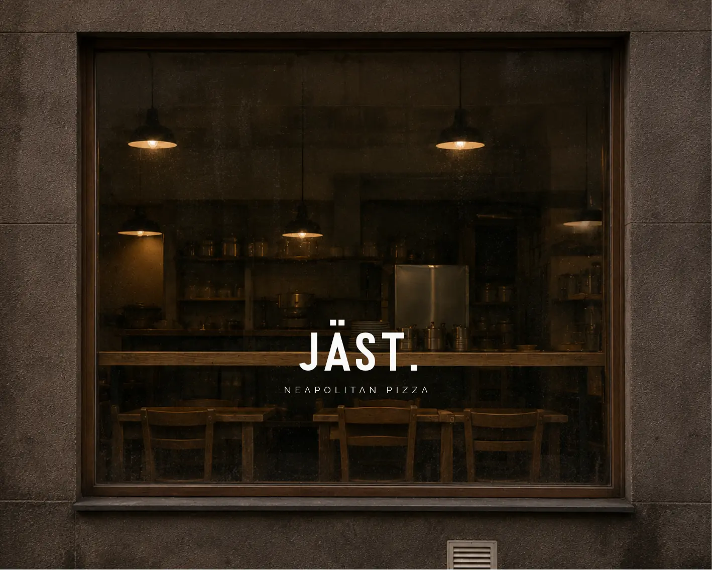 JÄST. visual concept: a warmly lit pizzeria seen through a dark street window